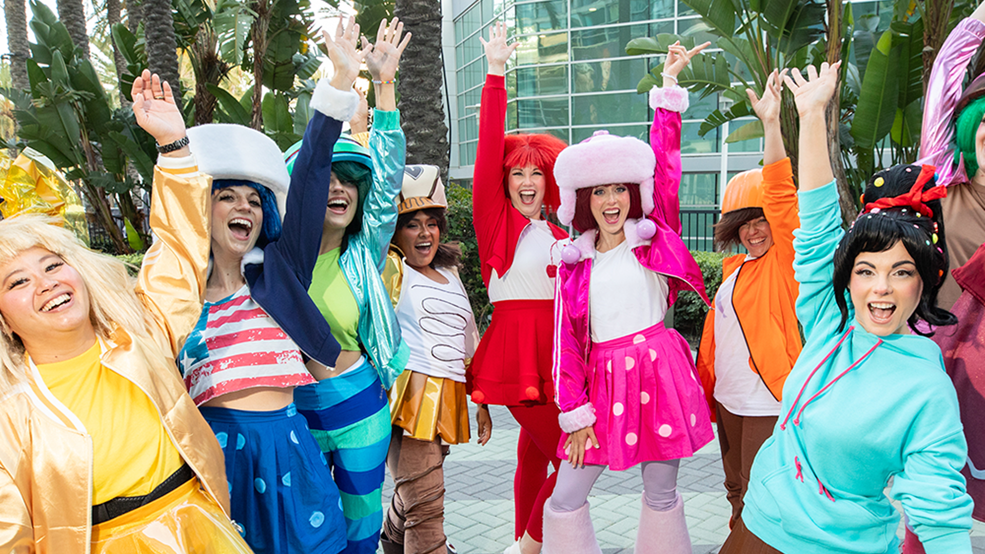 A group of fans wearing colorful, vintage-inspired Strawberry Shortcake and friends group cosplay costumes