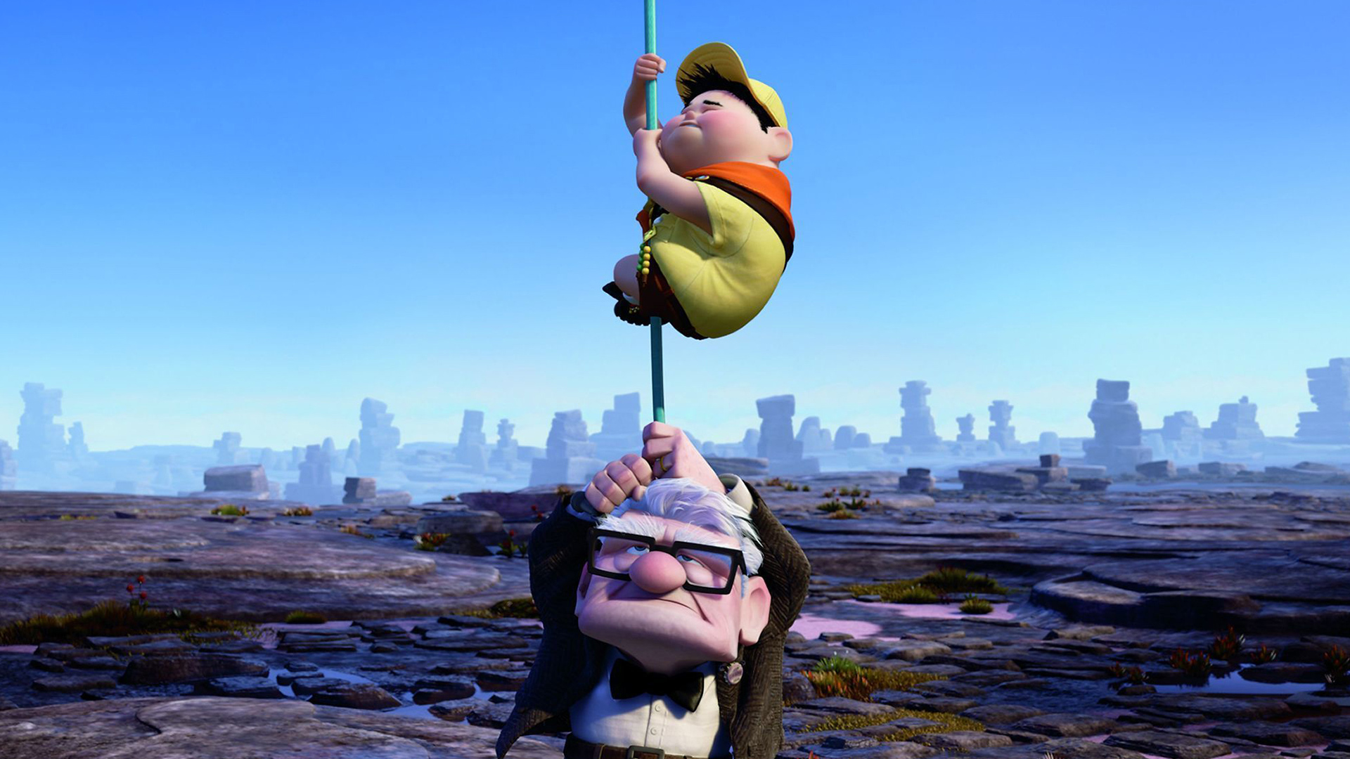 Russell holds tightly on a pole as Carl carries the pole above his head