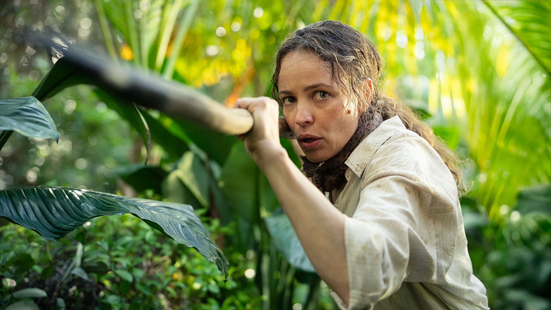 Rachel McAdams as Linda Liddle wielding a large stick as he hunts for boar,