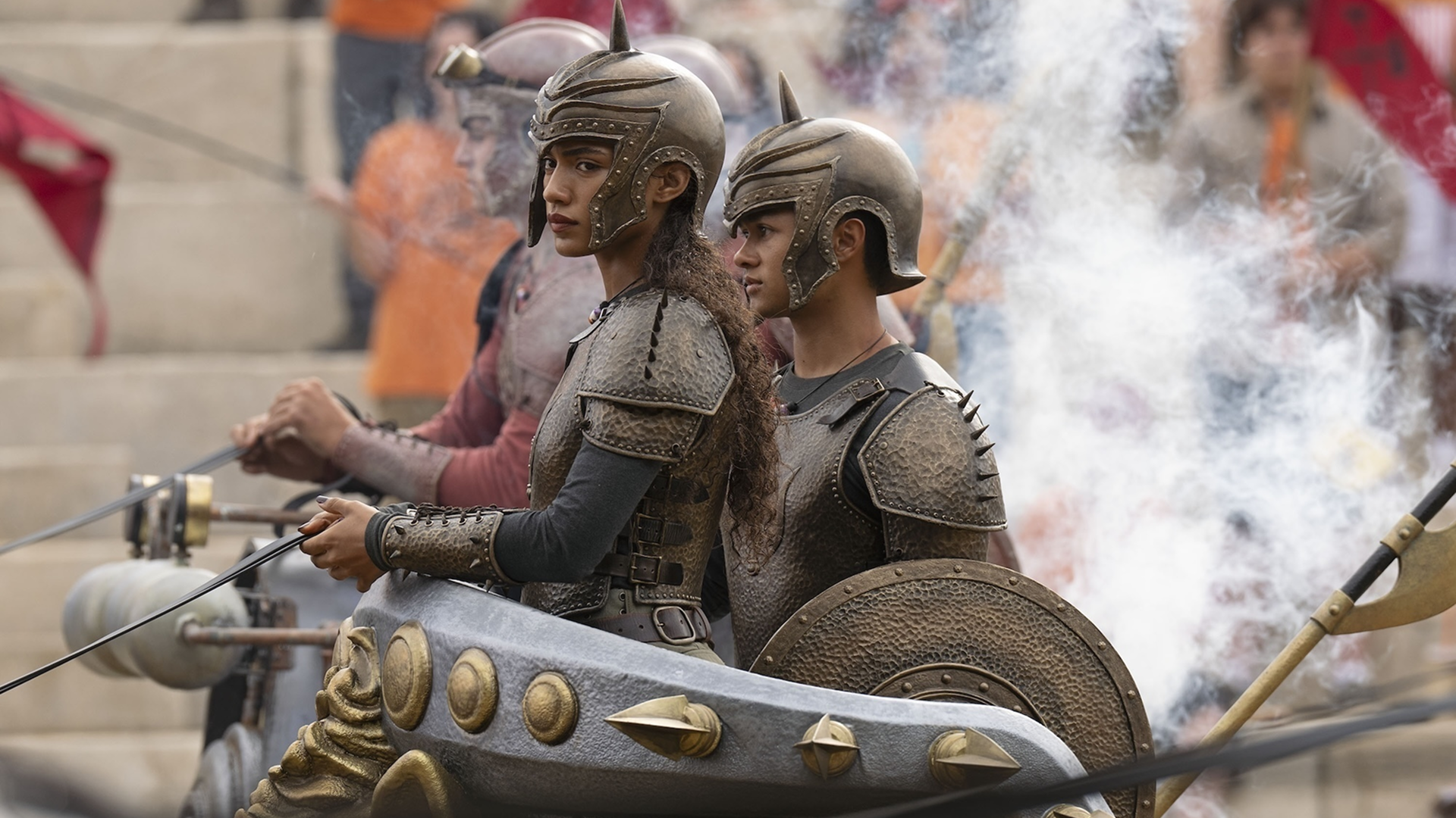 Clarisse La Rue (Dior Goodjohn) stands in a chariot in full armor.