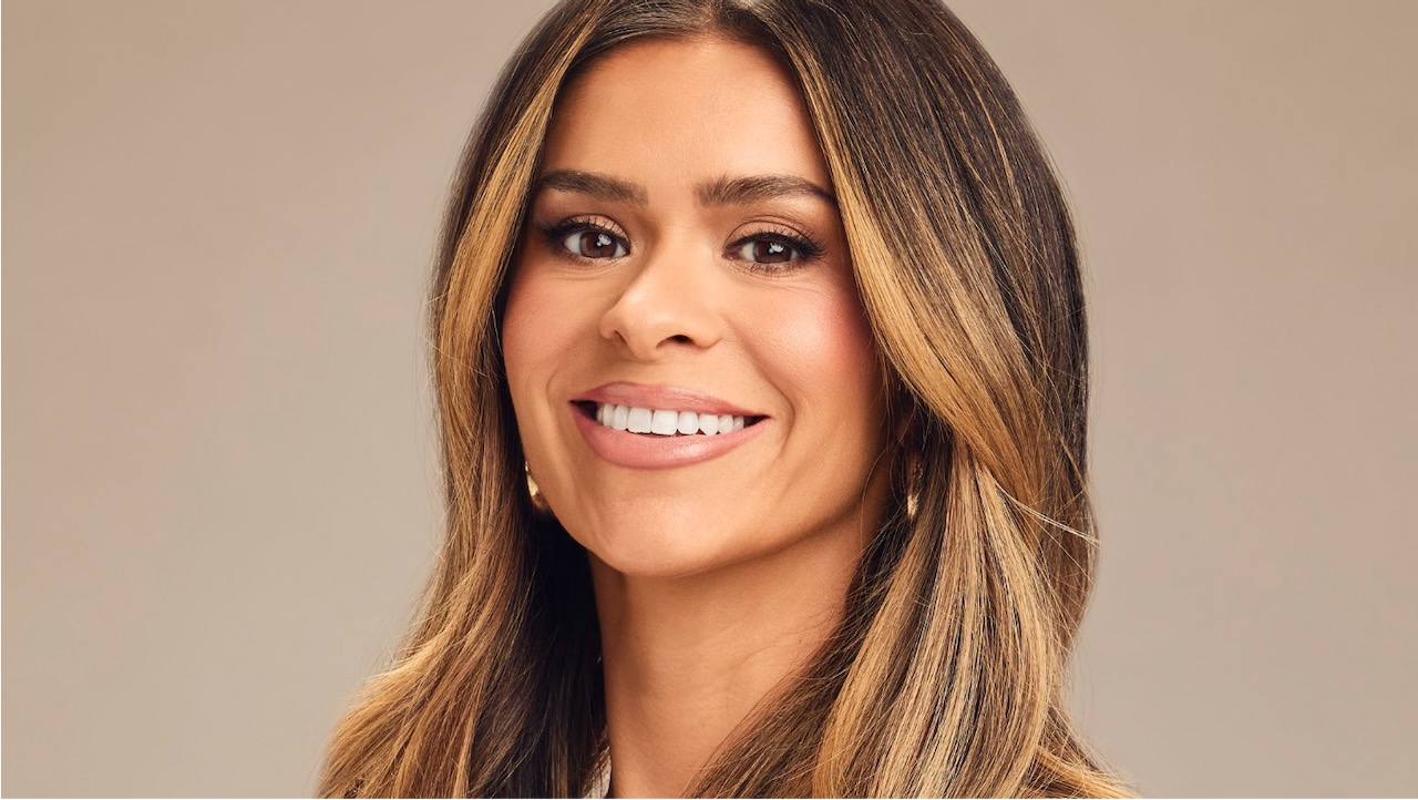 A headshot of Taylor Frankie Paul in front of a tan backdrop.