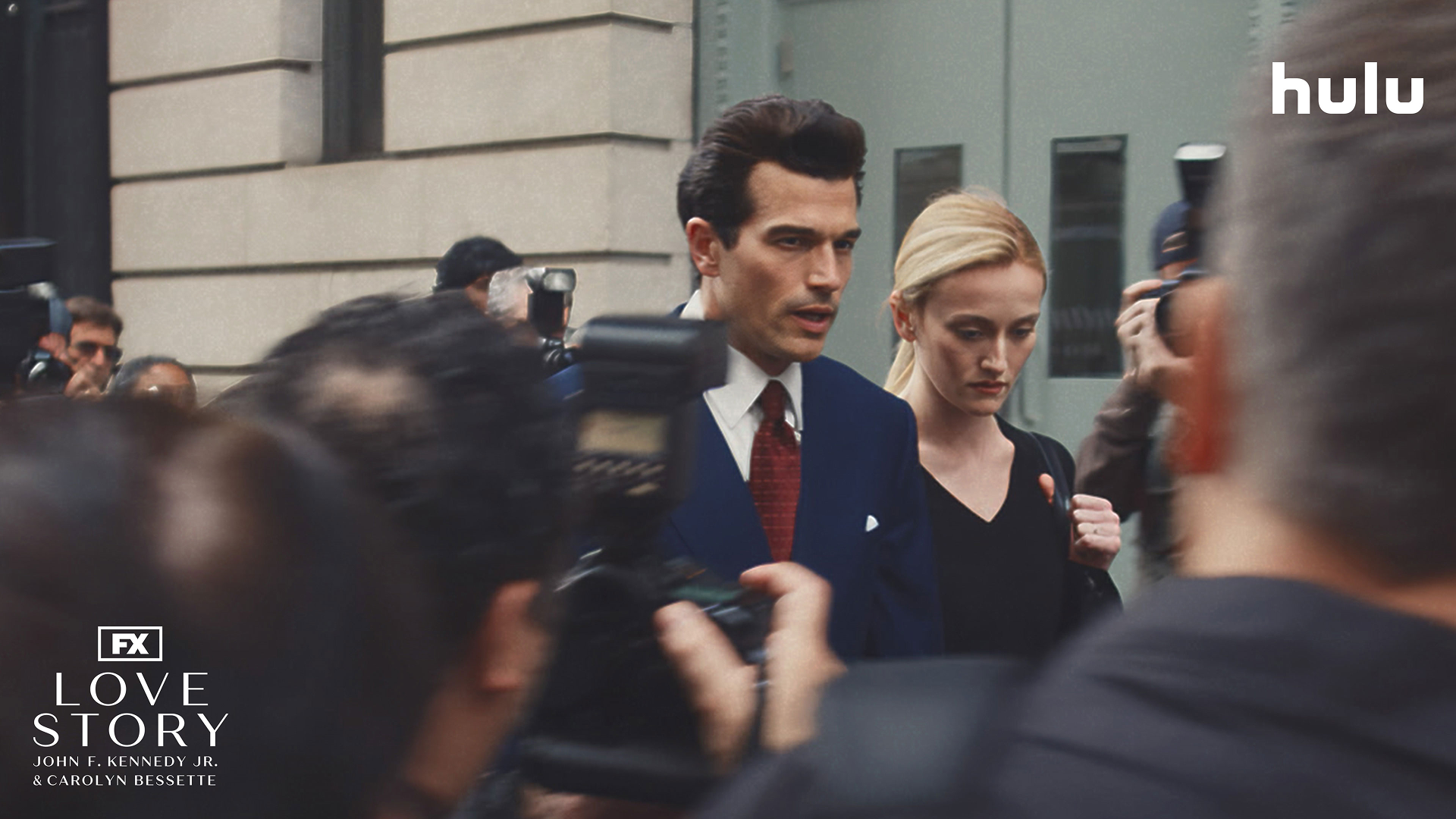 This image shows actors Paul Anthony Kelly and Sarah Pidgeon portraying John F. Kennedy Jr. and Carolyn Bessette-Kennedy