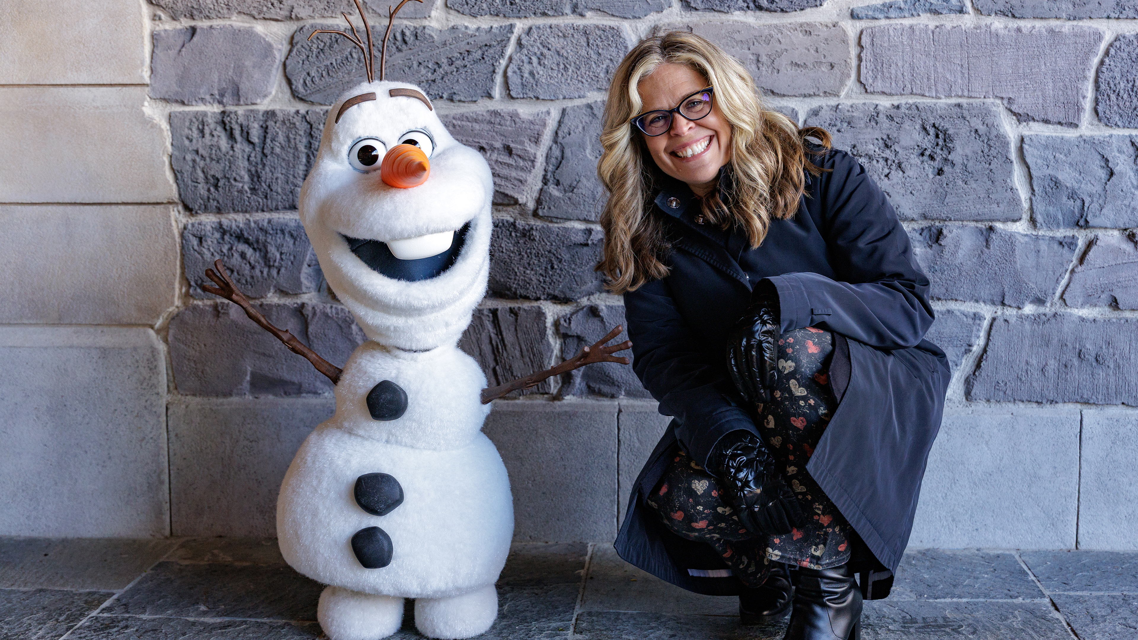 Jennifer Lee with an Olaf animatronic in Disney Worldbuilders.