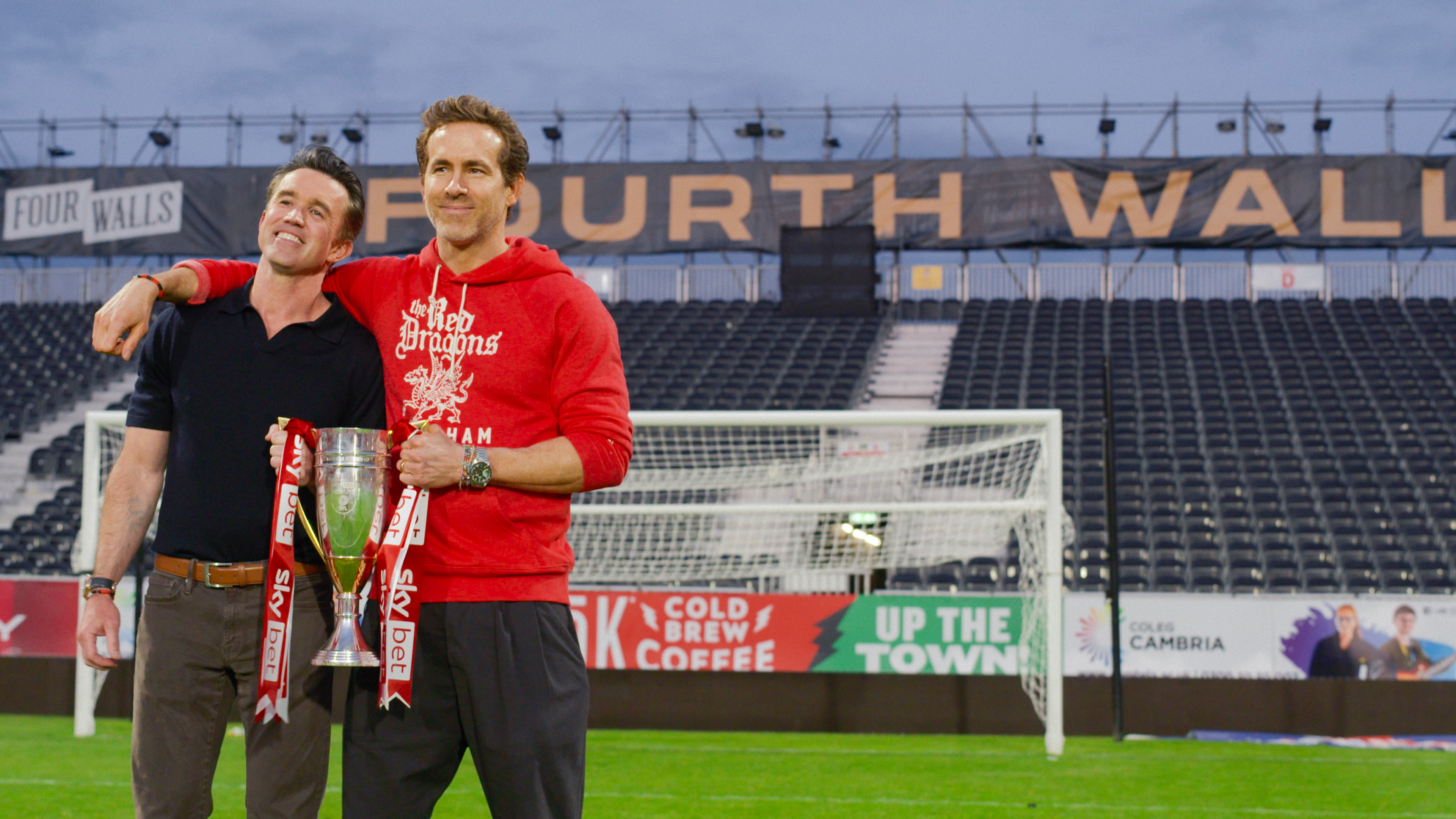 Rob Mac and Ryan Reynolds holding a trophy