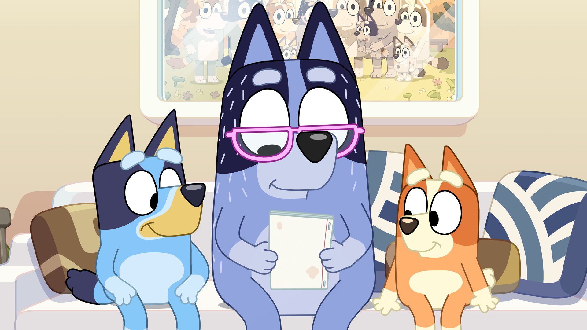 Bluey on the couch with her dad and sister.