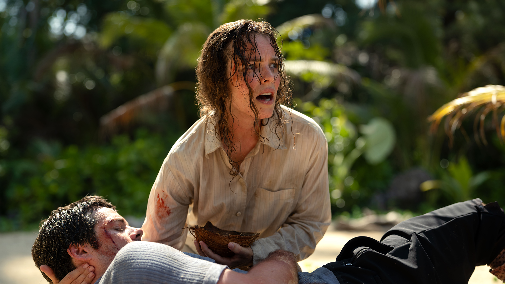 Linda cares for her boss Bradley on the island beach shortly after the plane crash.