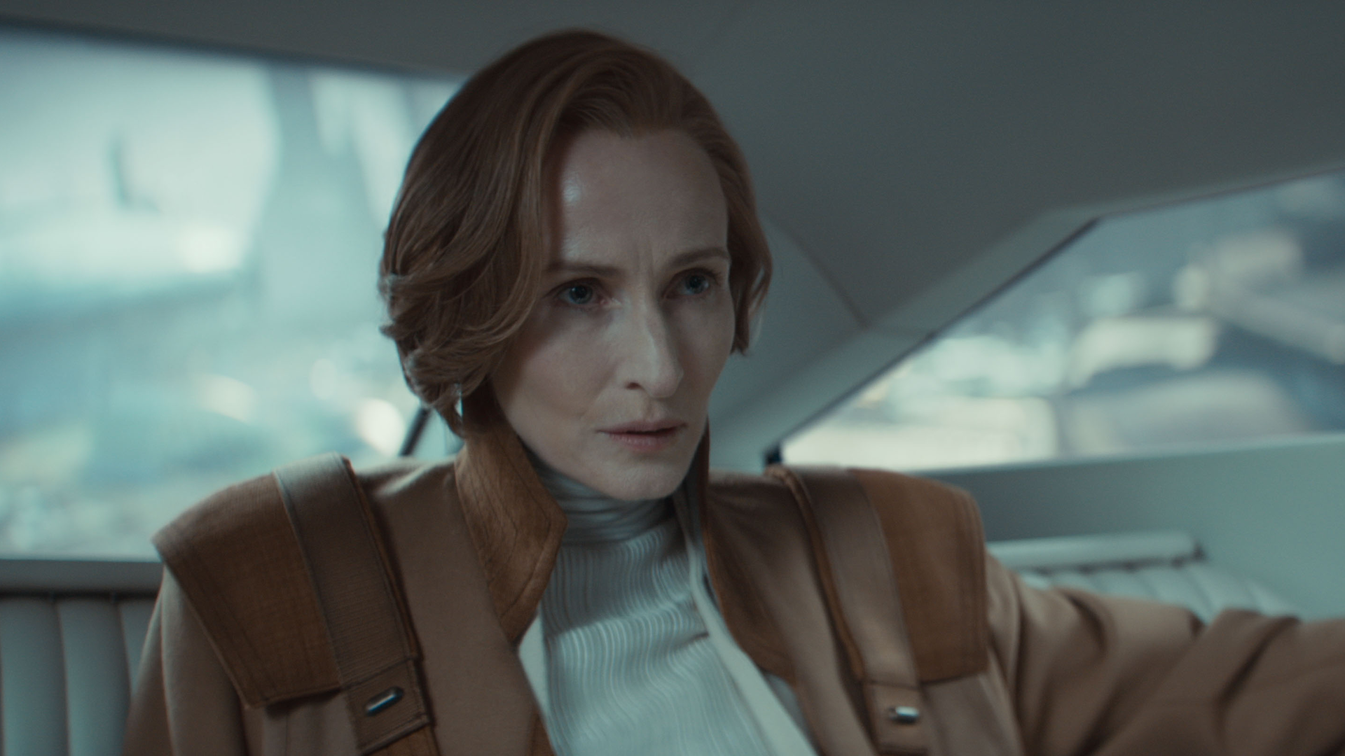 A concerned Mon Mothma (Genevieve O'Reilly) in the backseat of a vehicle.