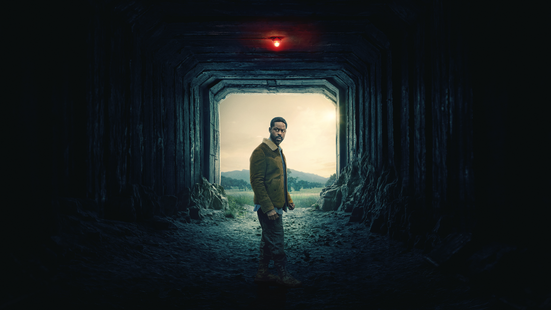 A promotional image of Xavier (Sterling K. Brown) inside an industrial-looking corridor