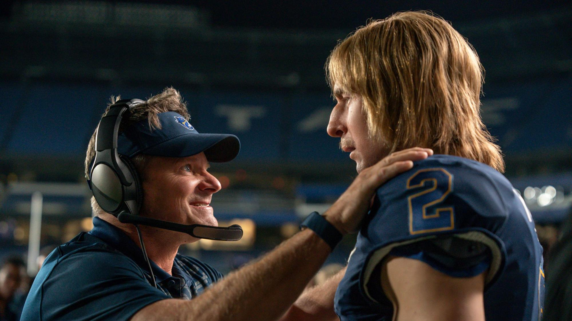 Coach Hudson (Steve Zahn) gives Chad Powers (Glen Powell) a pep talk during a match in the first season of the show.