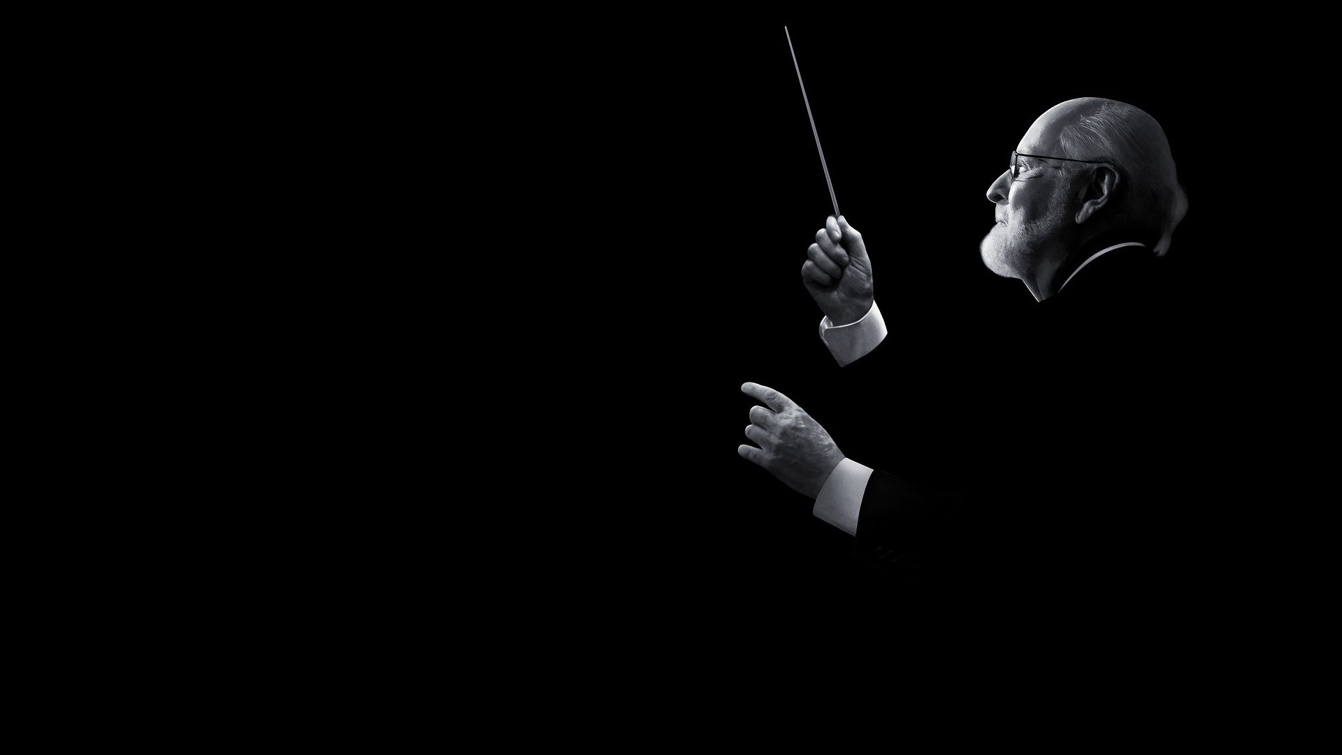 Black and white imagery of acclaimed composer John Williams.