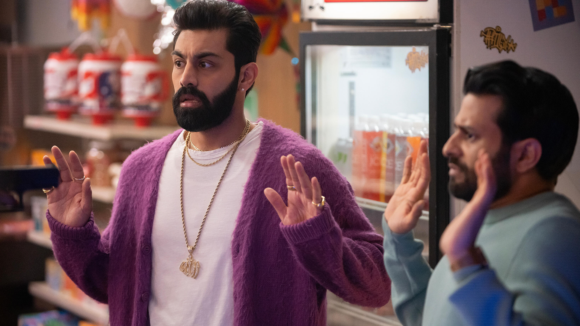 Mir (Asif Ali) e Raj (Saagar Shaikh) ssob a mira de uma arma na lojinha.