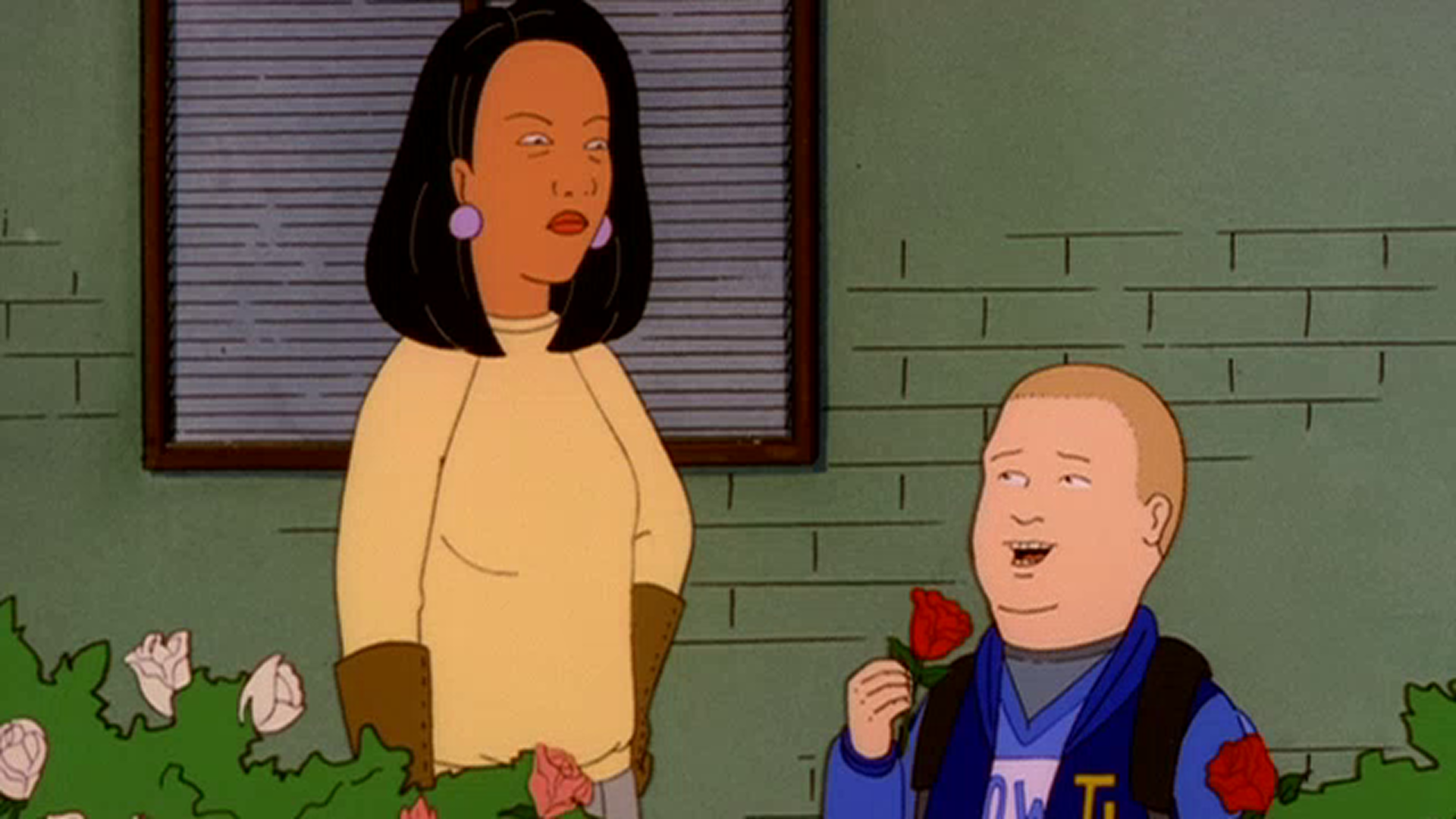 Bobby (Pamela Adlon) smiles and holds up a red rose beside Minh Souphanousinphone (Lauren Tom).