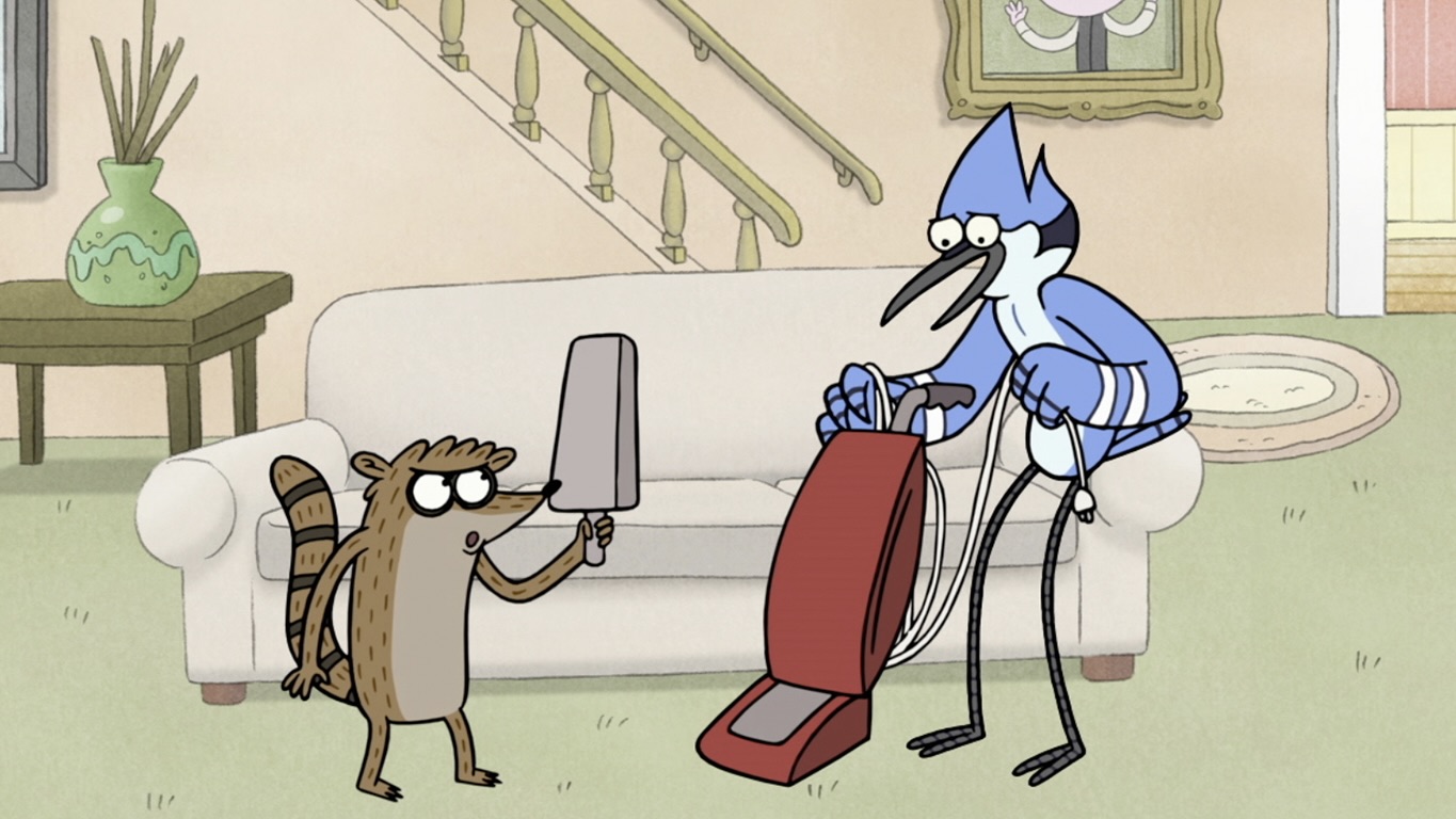Mordecai vacuums while Rigby holds a giant popsicle in a still from Regular Show.