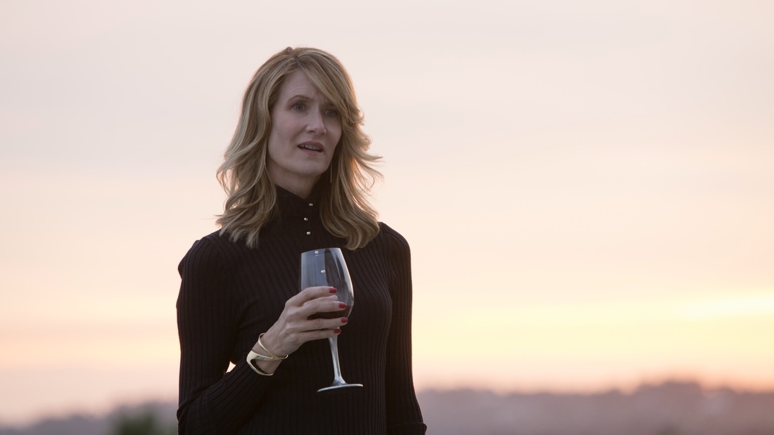 Laura Dern holing a wine glass starring in Big Little Lies