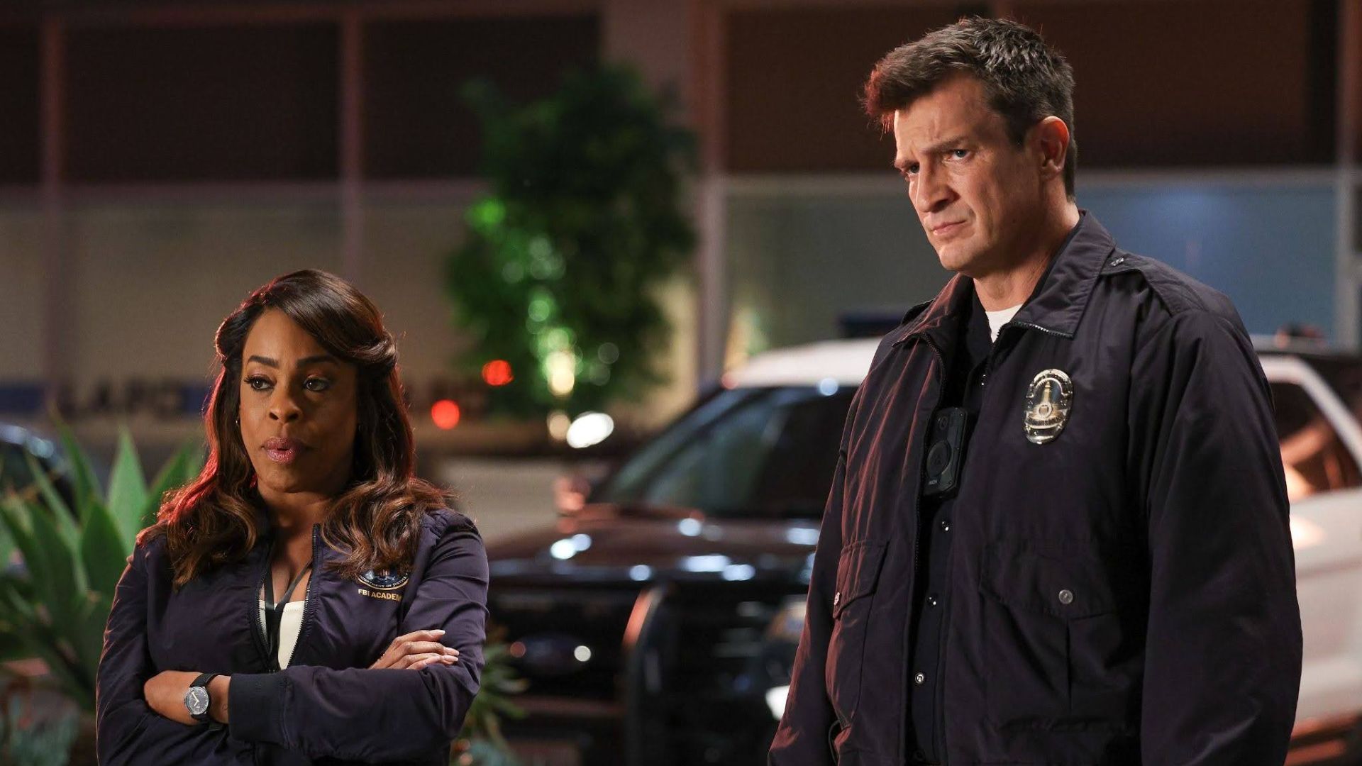 Simone Clark and Officer Nolan stand together at a nighttime crime scene
