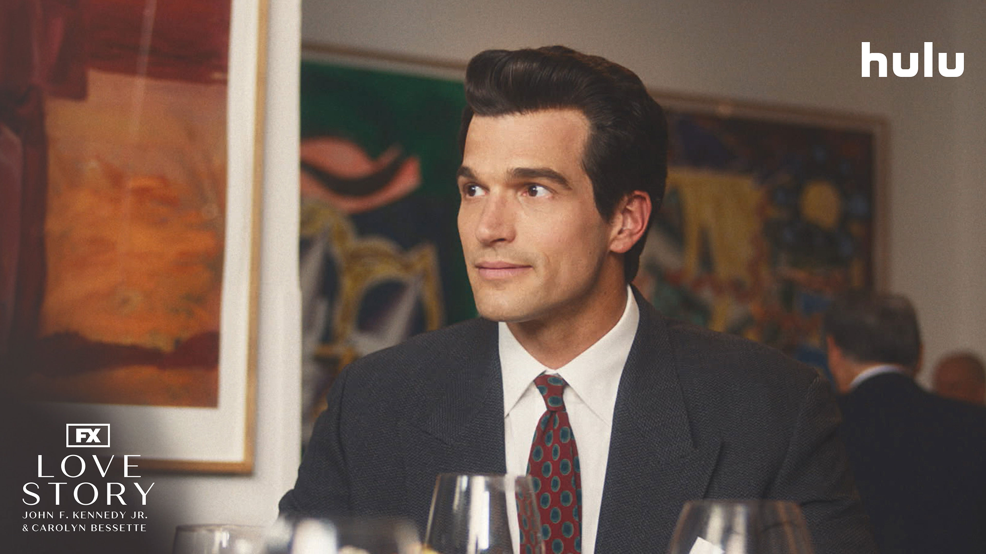 This image shows actor Paul Anthony Kelly portraying John F. Kennedy Jr. in the FX series Love Story: John F. Kennedy Jr. & Carolyn Bessette. 