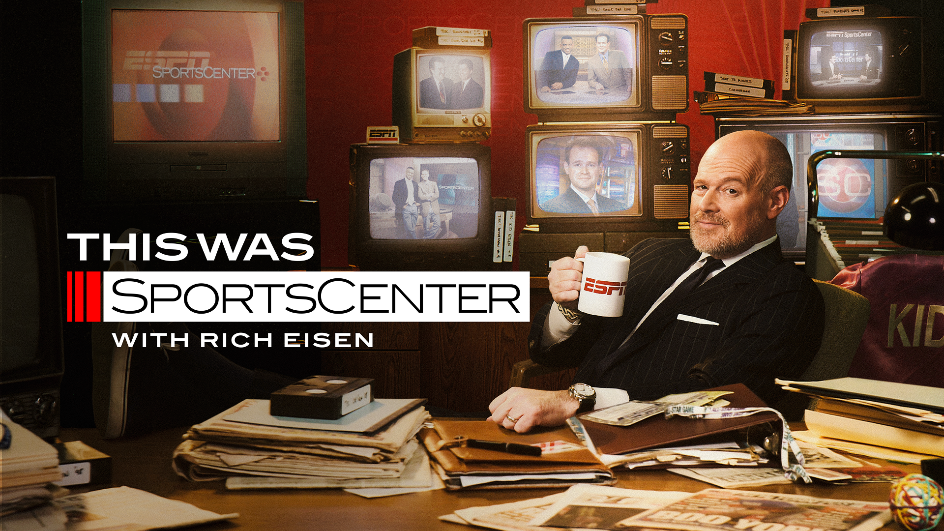 A promotional graphic features text reading "This Was SportsCenter with Rich Eisen," showing host Rich Eisen sitting at a messy desk holding an ESPN mug, surrounded by vintage television sets displaying older broadcast clips.