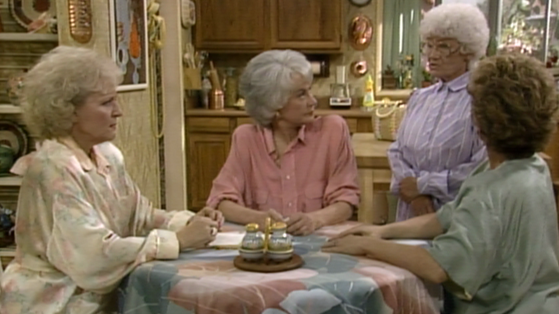 The Golden Girls around a table.