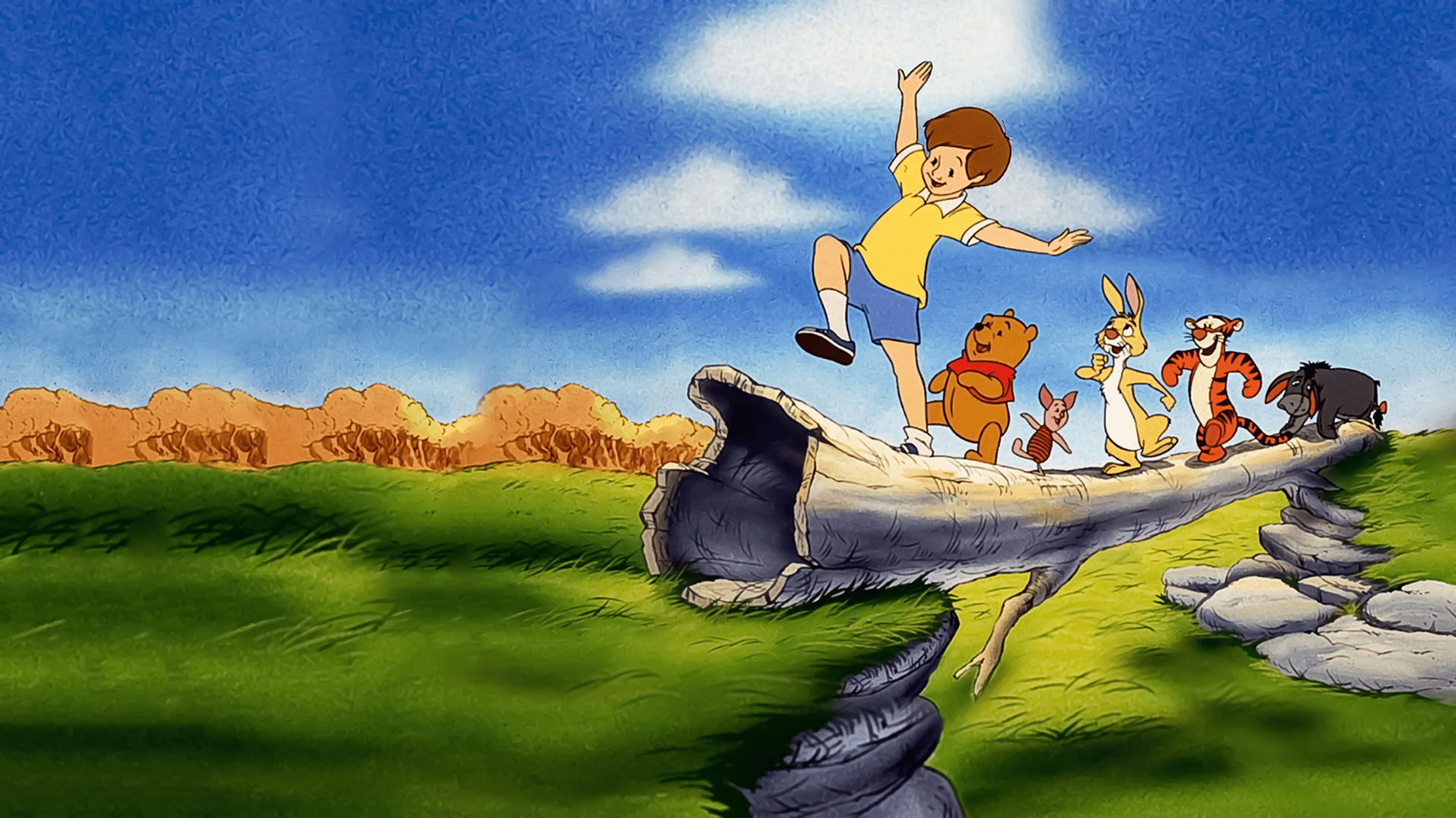The image features Christopher Robin balancing on a log, followed by Winnie the Pooh, Piglet, Rabbit, Tigger, and Eeyore in a scene from the 1997 animated film Pooh's Grand Adventure: The Search for Christopher Robin. 