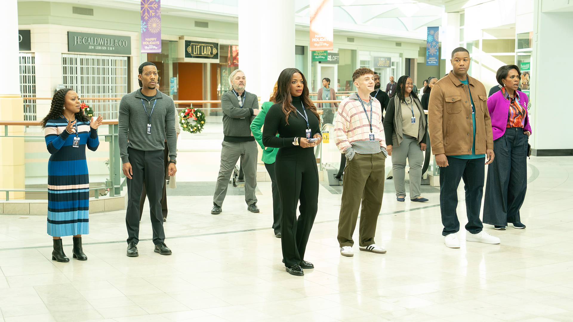 The cast of Abbott Elementary stand inside an abandoned mall