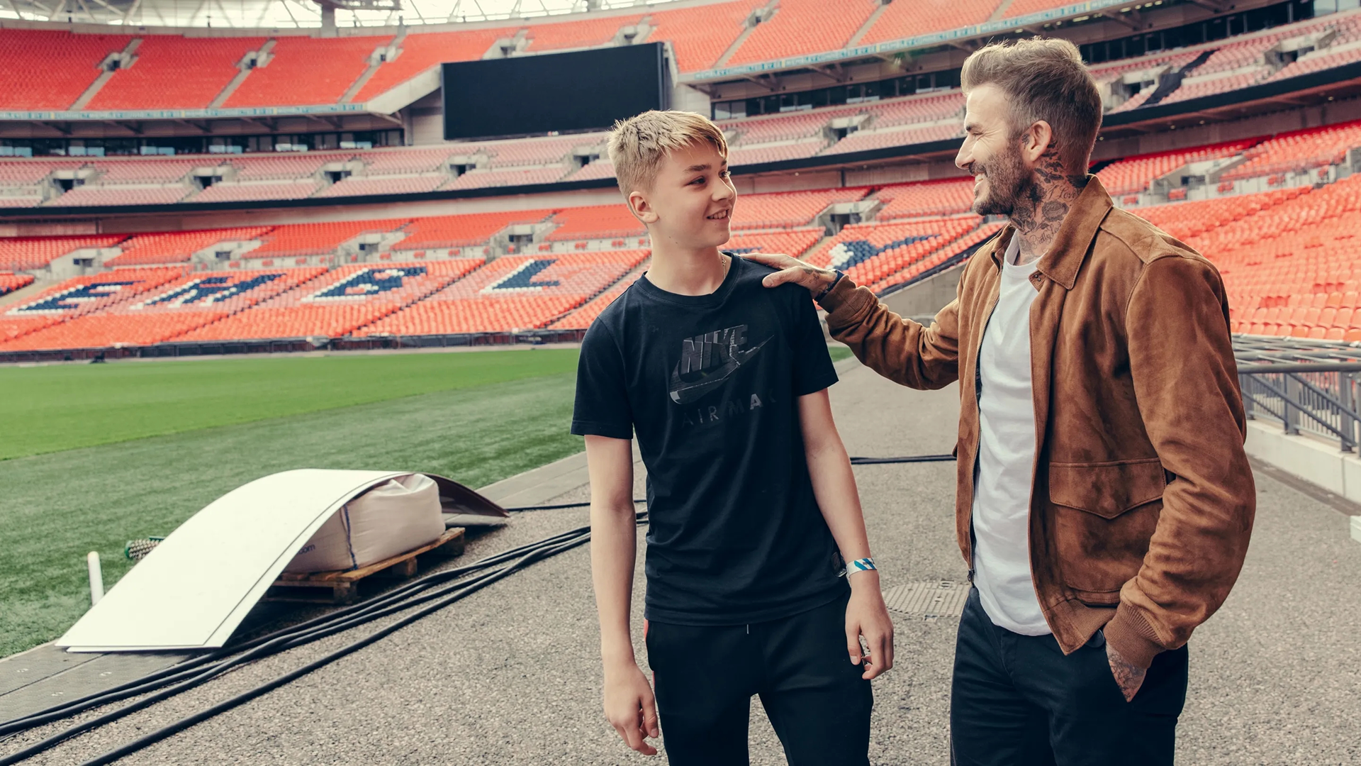 David Beckham embraces a squad member of the Westward Boys at Wembley Stadium in Save Our Squad with David Beckham (2022). 
