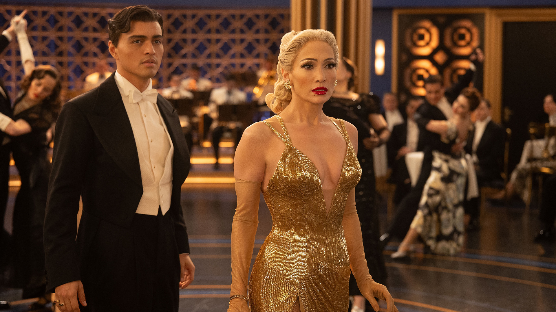 This image captures a moment from the 2025 musical film Kiss of the Spider Woman, featuring Jennifer Lopez as the fictional Old Hollywood icon, Ingrid Luna, and actor Tonatiuh. 