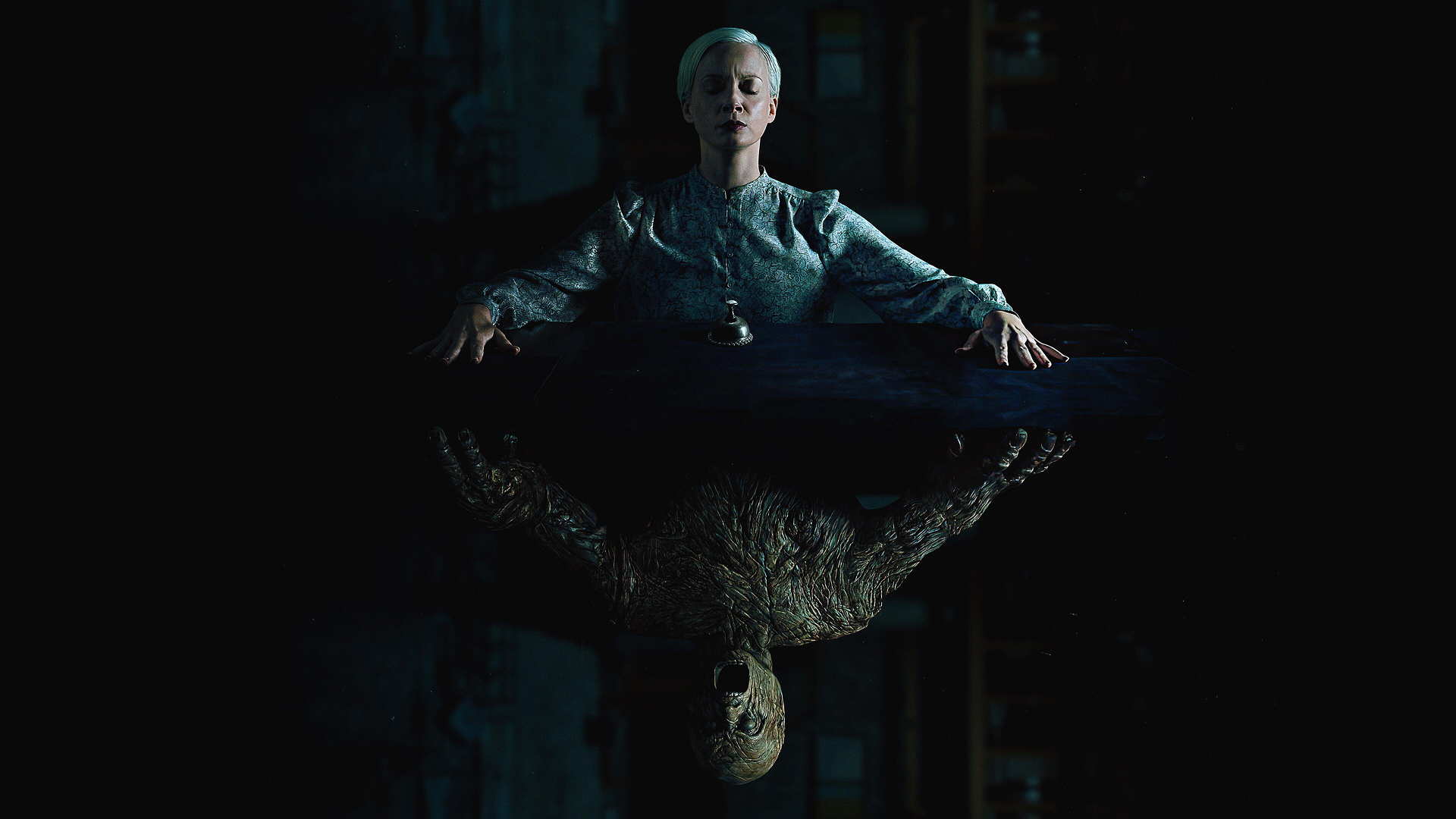 A woman sitting at a table, reflected in the table is a monster instead of the woman herself