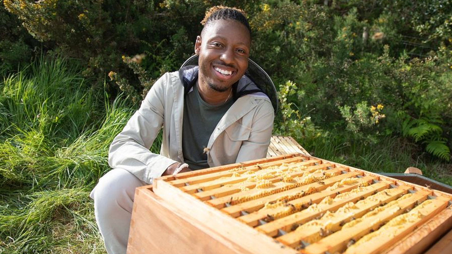Dr. Samuel Ramsey with a bee hive
