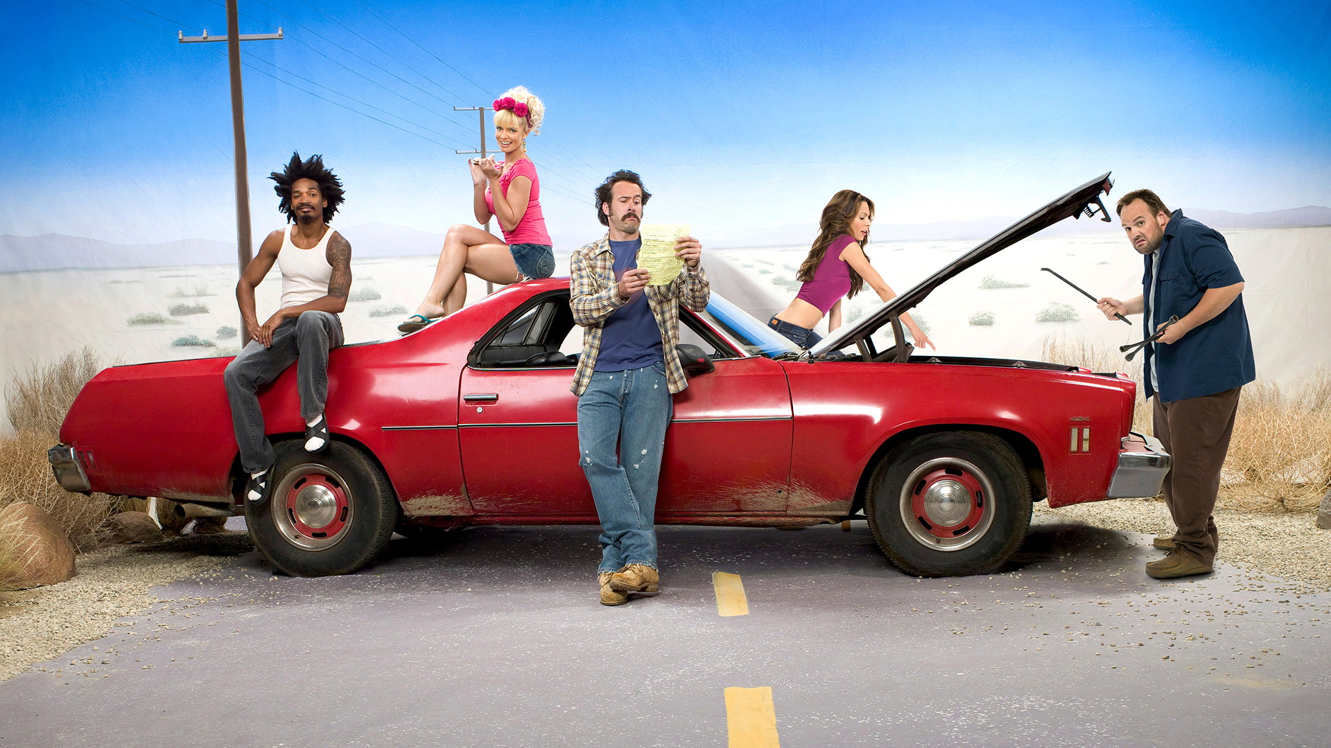 The cast of My Name is Earl are standing around a red Chevrolet El Camino