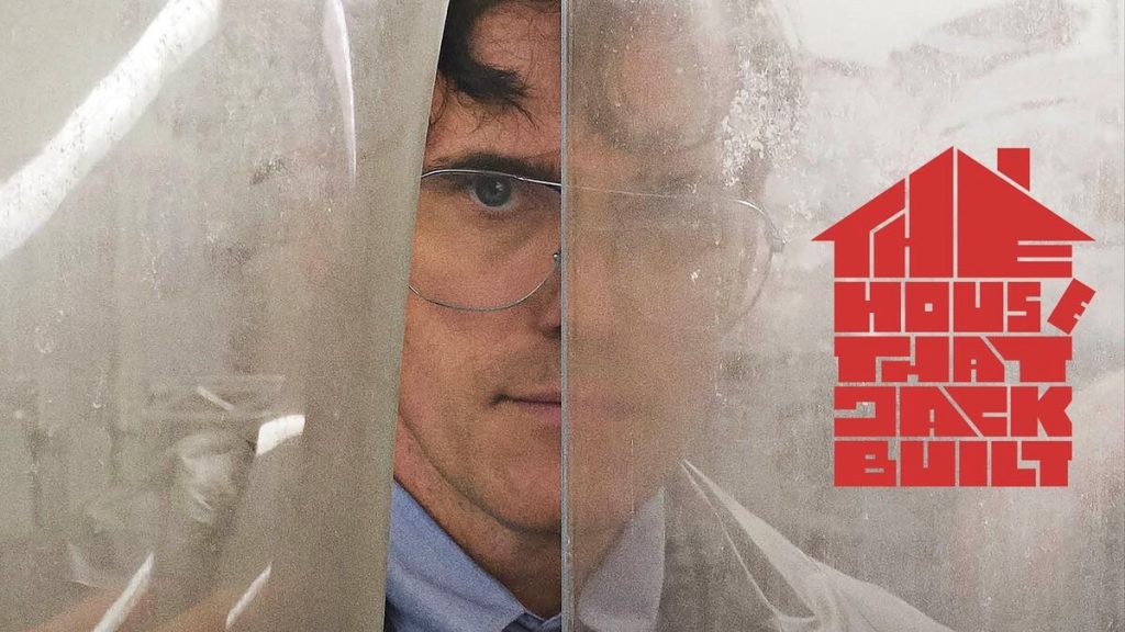 Poster for The House That Jack Built showing Matt Dillon’s character wearing glasses and a lab coat, looking through a fogged plastic sheet.