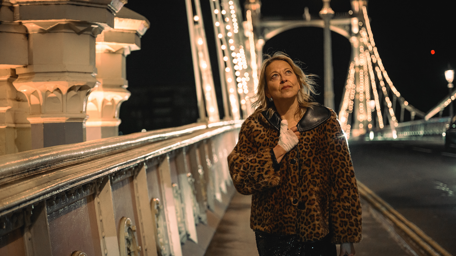 Alice (Nicola Walker) walks across Albert Bridge at night in a scene from the comedy-drama series Alice and Steve.