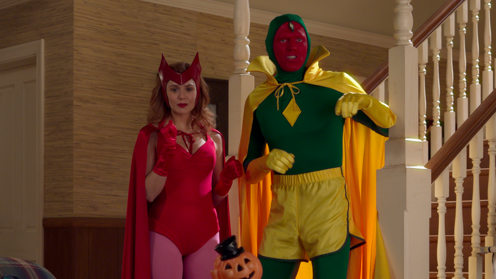 Wanda Maximoff (Scarlet Witch) and Vision in their Halloween costumes in an episode of Marvel Studios' WandaVision, Disney.