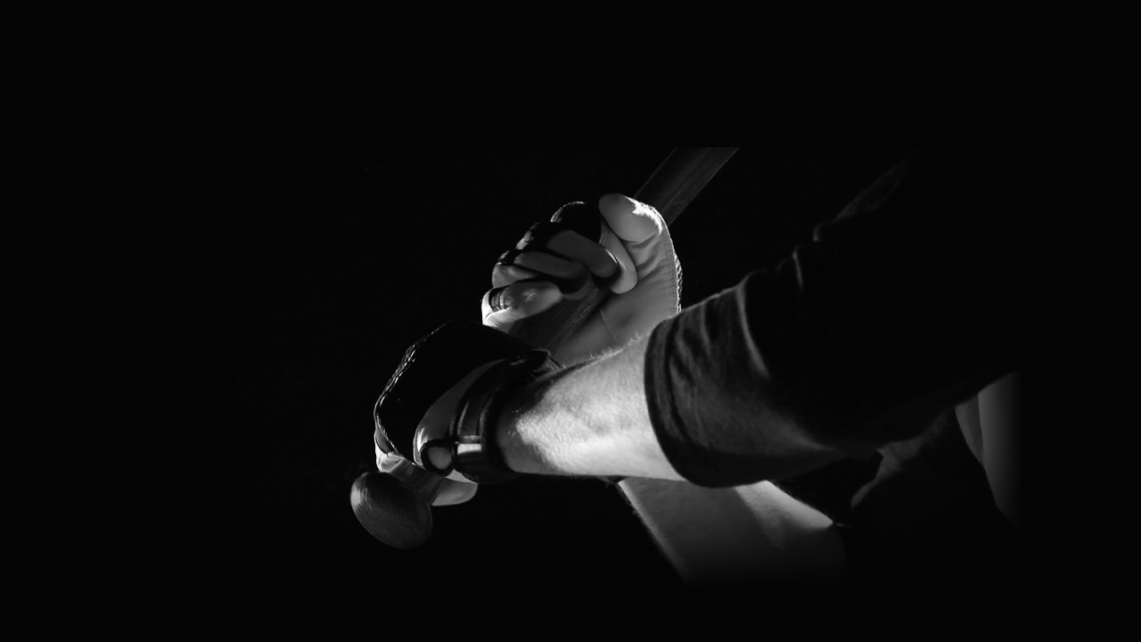Close up of hands gripping a baseball bat