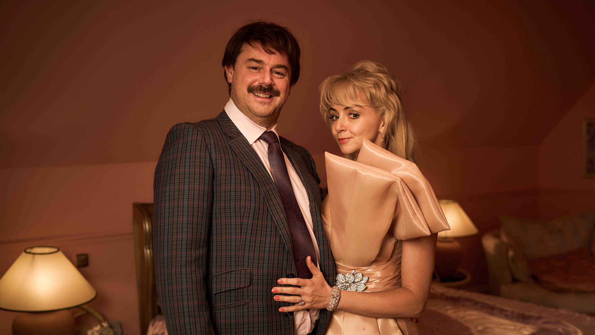 This image depicts Danny Dyer as Freddie Jones and Lisa McGrillis as Valerie Jones in the Disney+ series Rivals.