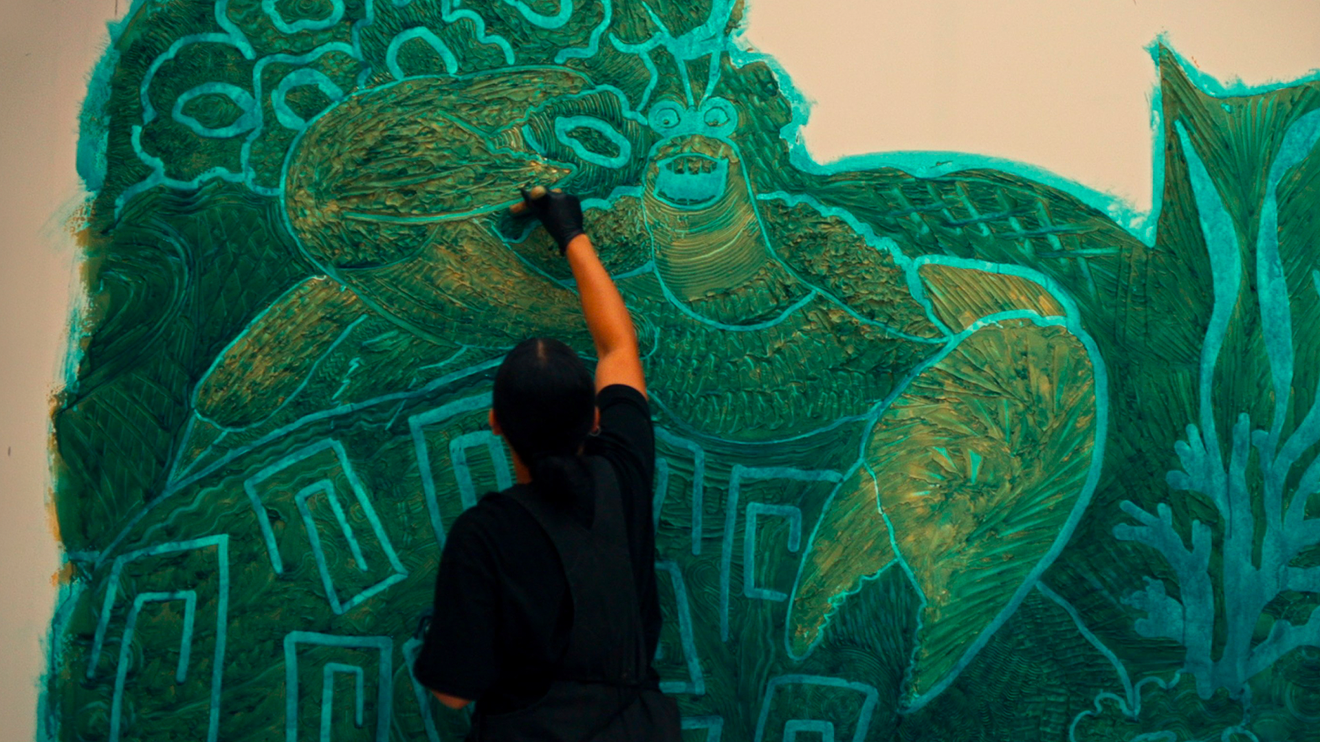 This is an artist creating a mural of Tamatoa the crab from Disney's Moana in the lobby of the new Island Tower at Disney's Polynesian Villas & Bungalows.