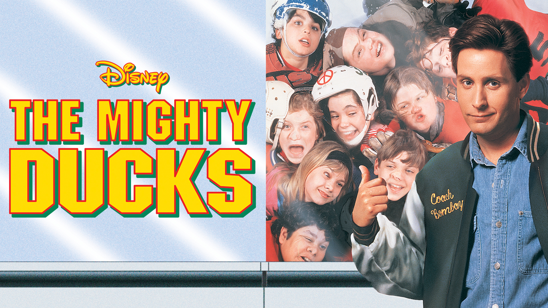 Coach Bombay (Emilio Estevez) stands in front of a group of young ice hockey players whose faces are smushed up against glass