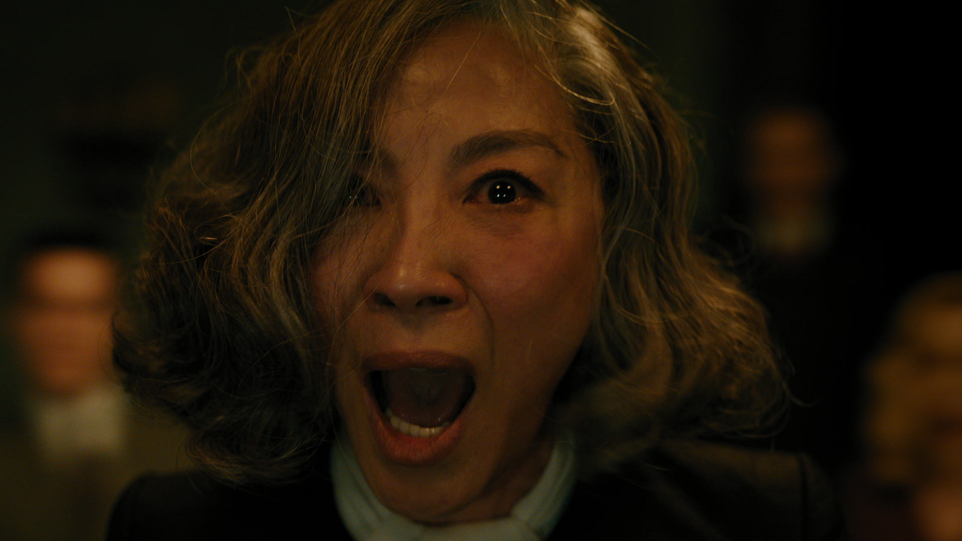 Joyce Reynolds (Michelle Yeoh) lets out a chilling scream with her eyes wide open in horror in A Haunting In Venice.