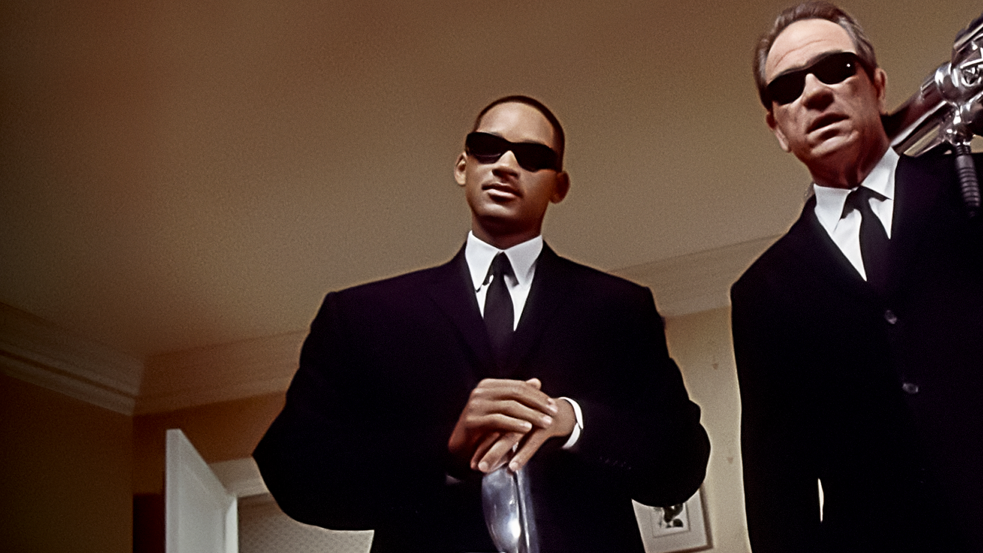 This image features characters from the Men in Black film franchise, starring Will Smith as Agent J and Tommy Lee Jones as Agent K.