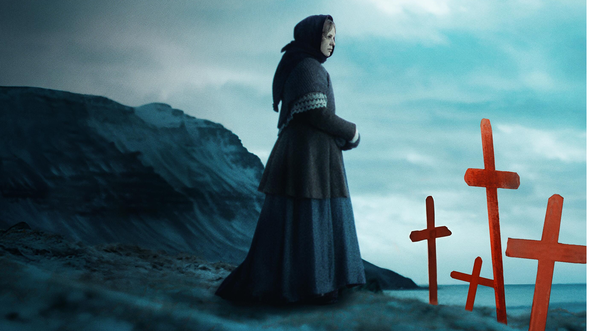 A woman standing at the end of a cliff, next to a number of red crosses seemingly marking graves