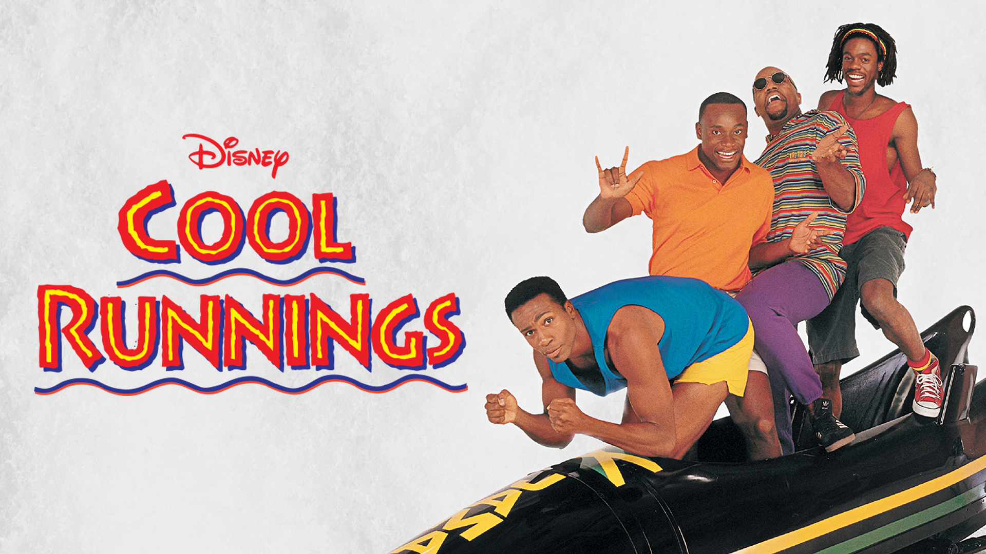 The bobsled team pose on a bobsled dressed in shorts and t-shirts