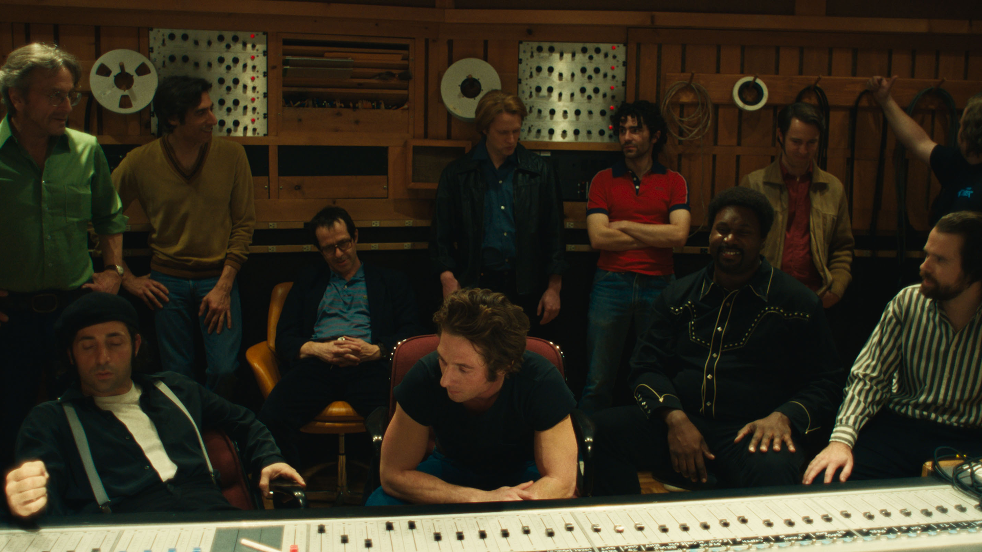 Bruce Springsteen (Jeremy Allen White) sits in a recording studio surrounded by other characters.